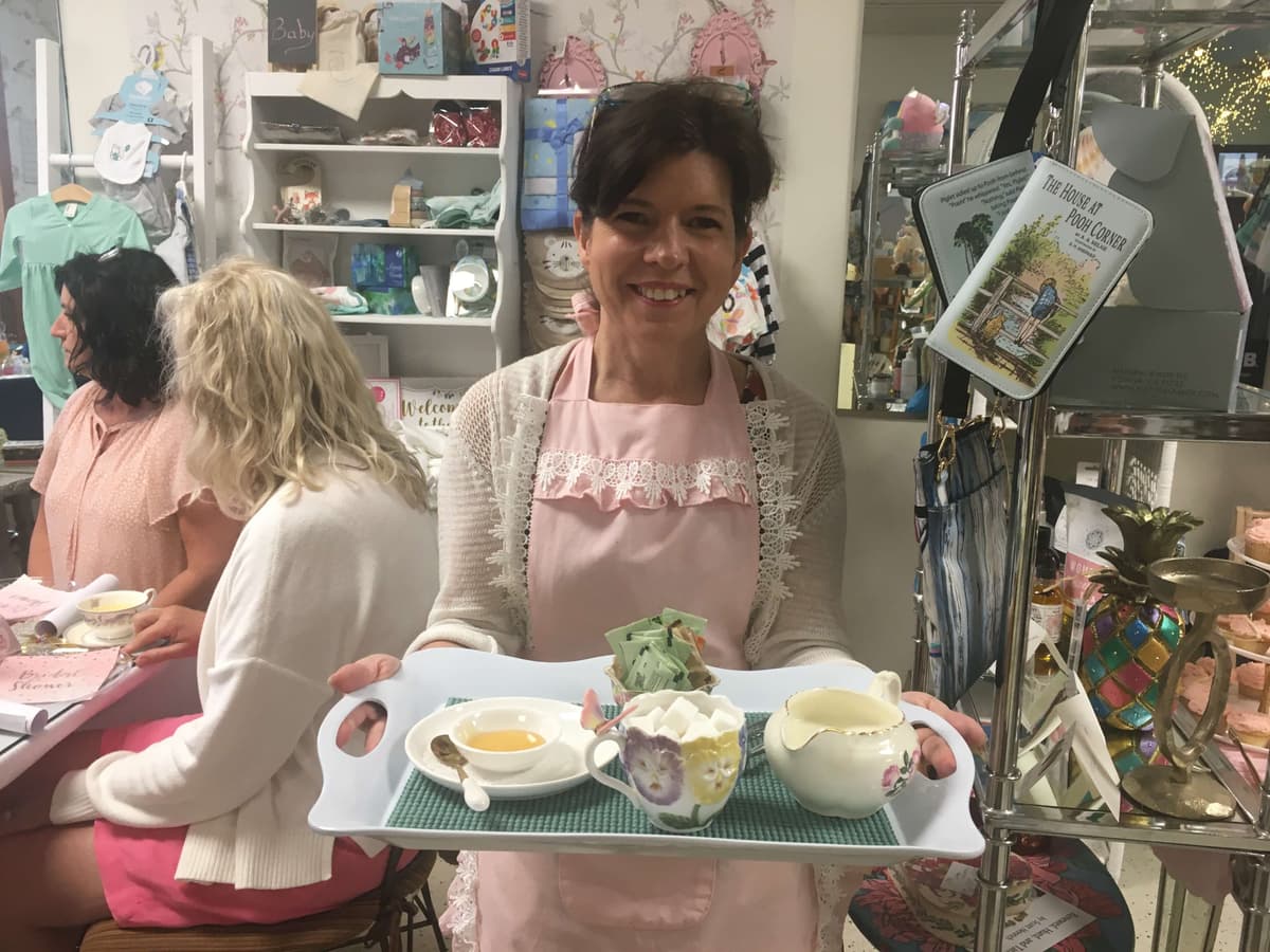 Staff member serving afternoon tea tray